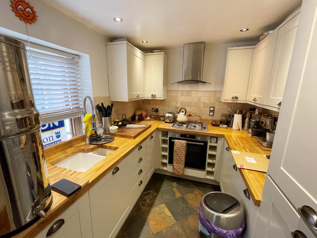 Lot: 65 - WELL-PRESENTED TWO-BEDROOM HOUSE - Kitchen with wooden worktops